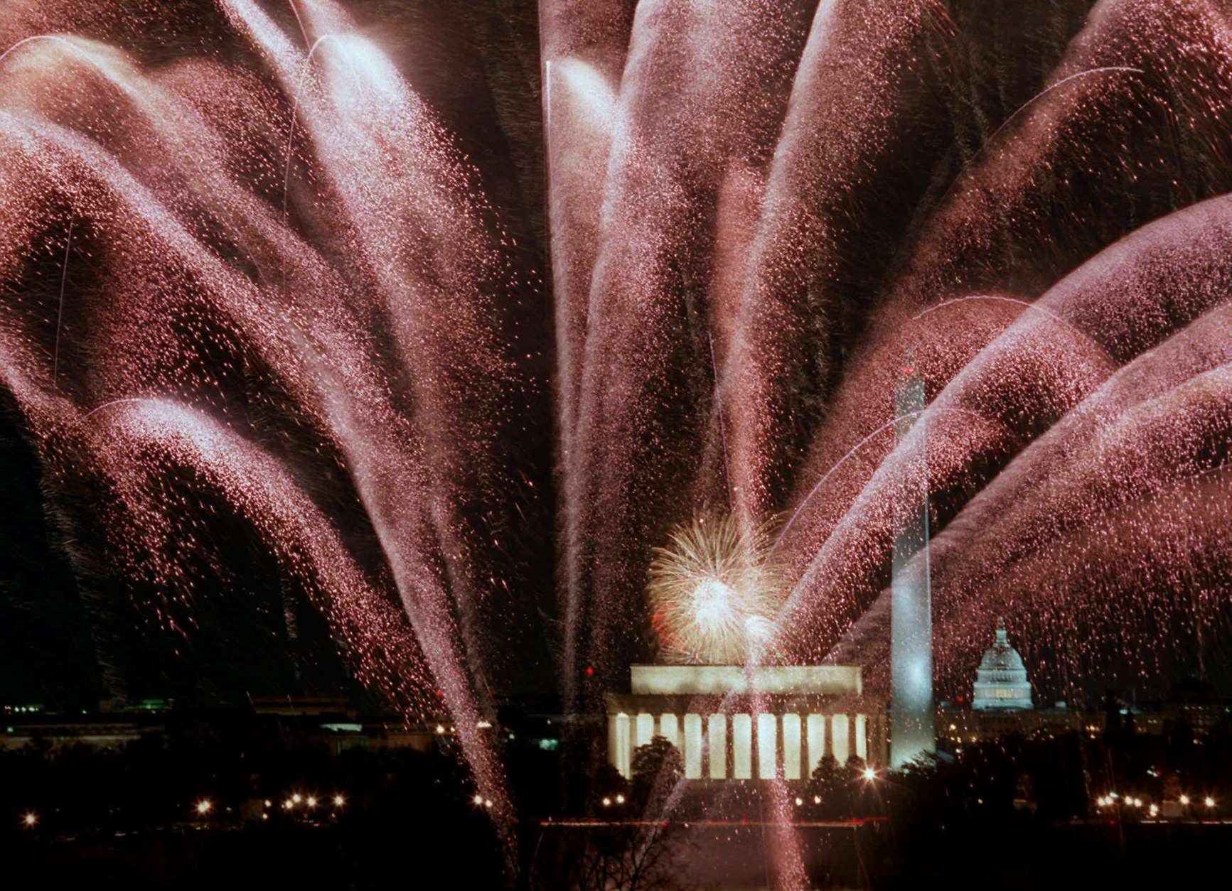 Fireworks cascade over the Lincoln Memorial, Washington Monument and the Capitol Saturday Jan. 18, 1997 during the inaugural fireworks display. Nine sites around Washington set off fireworks in honor of President Clinton's inauguration. (AP Photo/Mark Wilson)