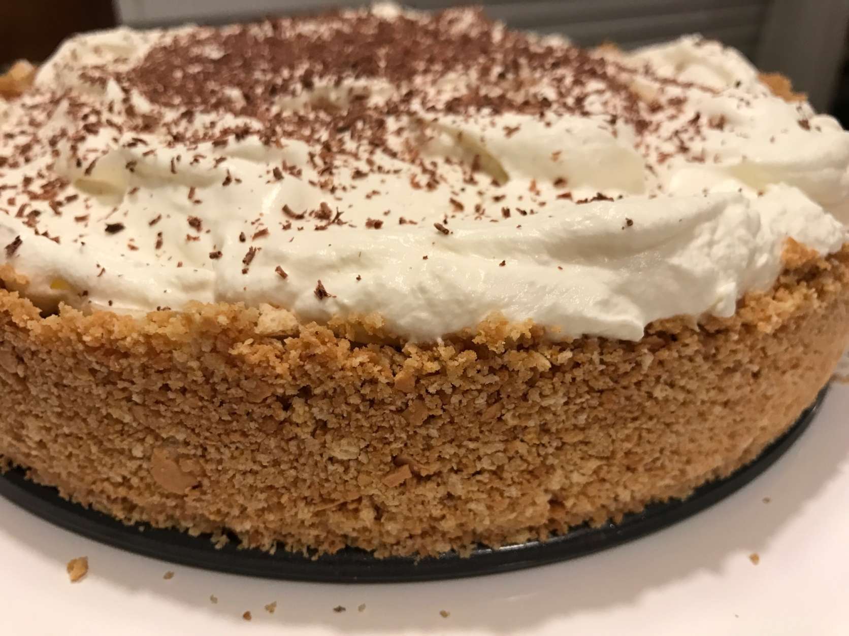 Banoffee pie is made using crumbled digestive biscuits and butter for the base. Bananas, sticky toffee and whipped cream are layered on top. (WTOP/Rachel Nania) 