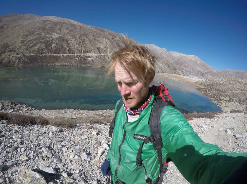 Burch next to a high altitude glacier lake showing signs of evaporation. (Courtesy: Sean Burch)
