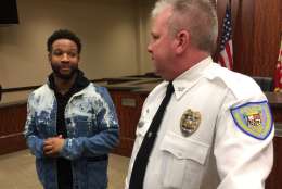 Brandon Roberson chats with Laurel Police Chief Richard McLaughlin following the announcemnet that an arrest had been made in the 2005 murder of Roberson's  uncle, Brian Moses.