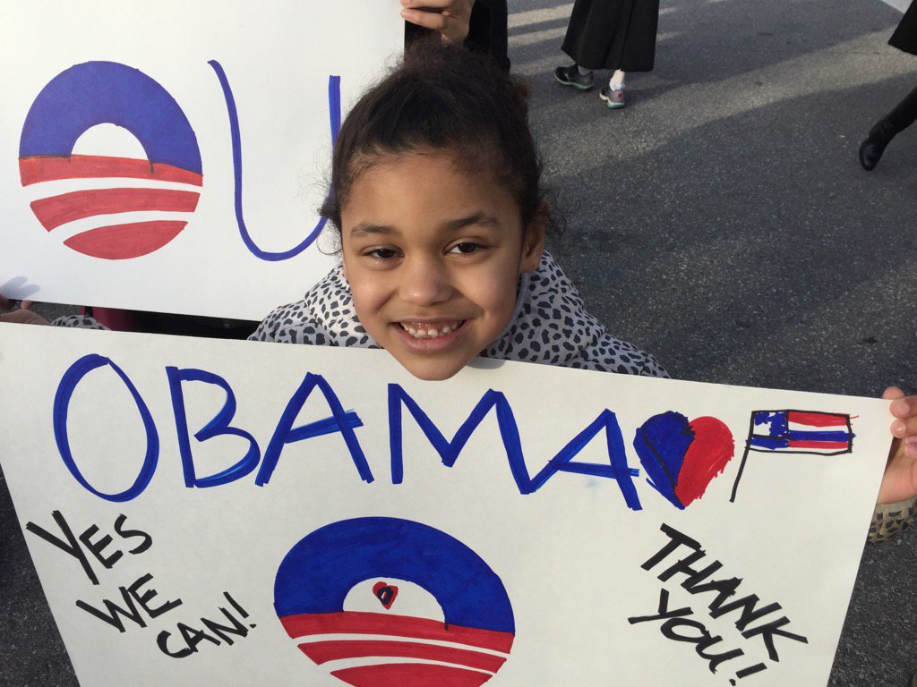 Londyn, an 8-year-old from Rockville, attends a small gathering at 15th/Pennslyvania Avenue in NW to say goodbye to President Barack Obama. (WTOP/Kristi King)