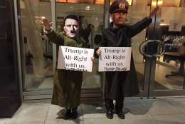 Costumed bystanders stood near the National Press Club, the site of the DeploraBall. (WTOP/Michelle Basch)