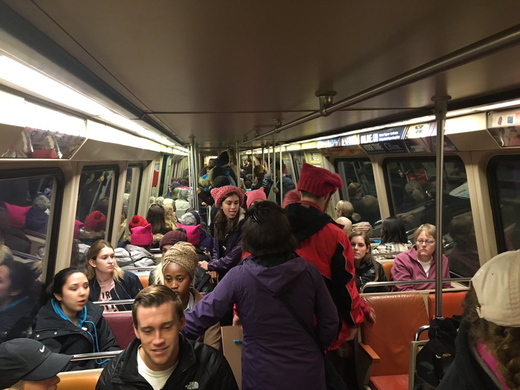 A sea of pink hat-wearing people ride the train toward the Women's March on Washington. Trains began to fill up at Union Station around 8:30 a.m. Saturday, Jan. 21, 2017, the day of the march. (WTOP/Max Smith)