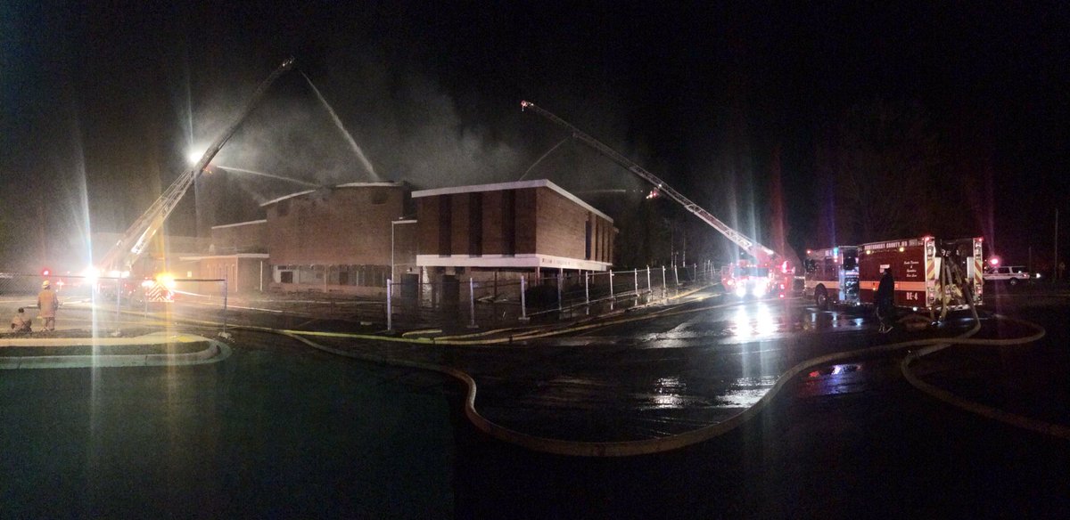 Ladder trucks pour water onto the roof of the gym to fight the blaze. (Courtesy Pete Piringer)