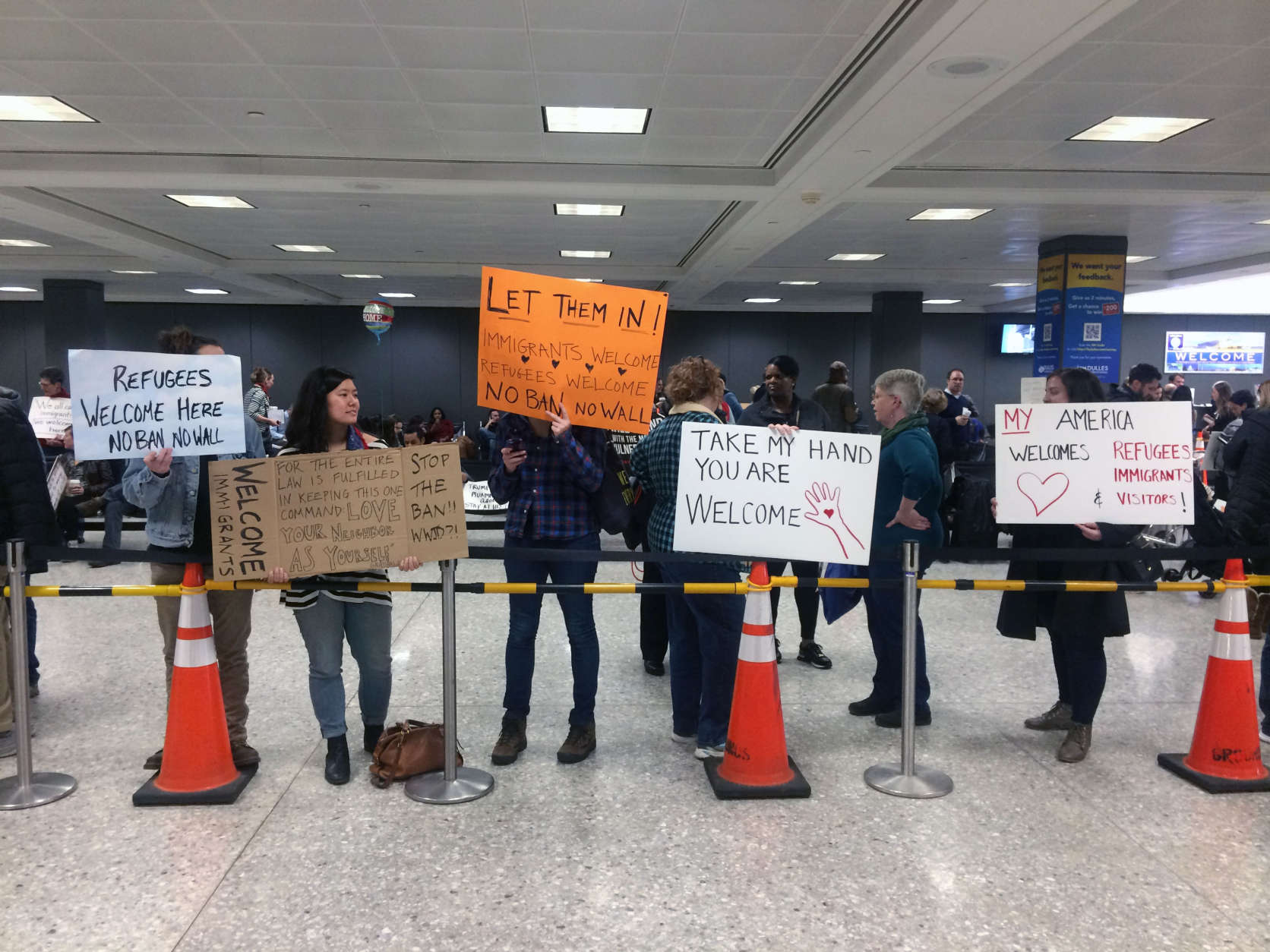 Demonstrators stage a protest at Dulles International Airport for a second day on Sunday, Jan. 29, 2017. (WTOP/Dick Uliano)