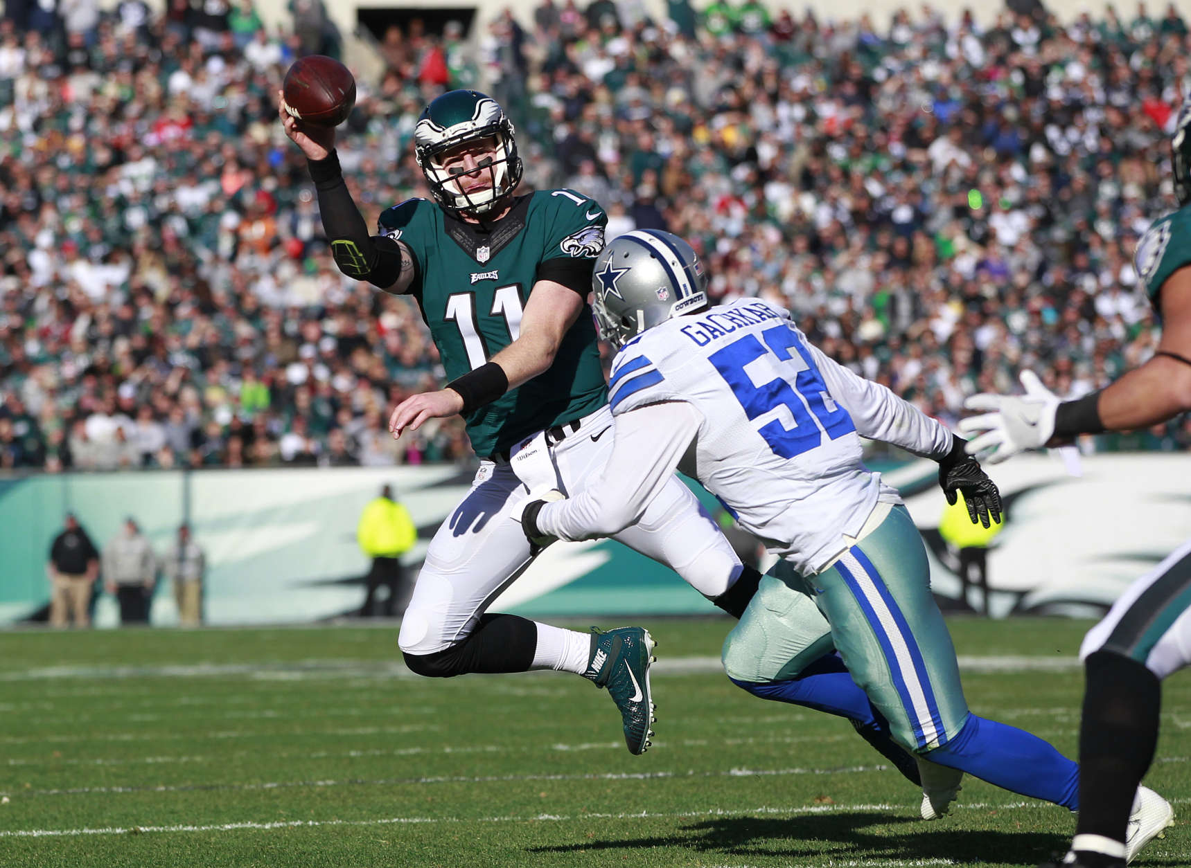 PHILADELPHIA, PA - JANUARY 01: Carson Wentz #11 of the Philadelphia Eagles looks to pass as Andrew Gachkar #52 of the Dallas Cowboys pursues during the first quarter of a game at Lincoln Financial Field on January 1, 2017 in Philadelphia, Pennsylvania. (Photo by Rich Schultz/Getty Images)