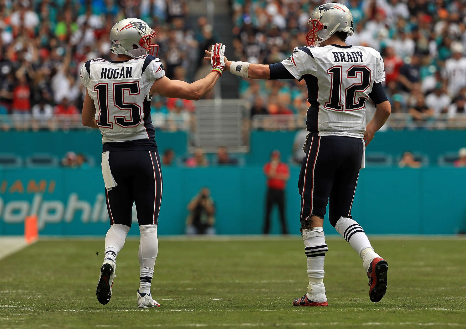 MIAMI GARDENS, FL - JANUARY 01: Tom Brady #12 and Chris Hogan #15 of the New England Patriots celebrate a touchdown during a game against the Miami Dolphins at Hard Rock Stadium on January 1, 2017 in Miami Gardens, Florida.  (Photo by Mike Ehrmann/Getty Images)