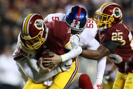 LANDOVER, MD - JANUARY 01: Quarterback Kirk Cousins #8 of the Washington Redskins is sacked by defensive back Leon Hall #25 and outside linebacker Devon Kennard #59 of the New York Giants in the third quarter at FedExField on January 1, 2017 in Landover, Maryland. (Photo by Rob Carr/Getty Images)