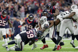 HOUSTON, TX - JANUARY 07: Latavius Murray #28 of the Oakland Raiders is tackled by Whitney Mercilus #59, Antonio Smith #94 and Jadeveon Clowney #90 of the Houston Texans in the AFC Wild Card game at NRG Stadium on January 7, 2017 in Houston, Texas.  (Photo by Thomas B. Shea/Getty Images)