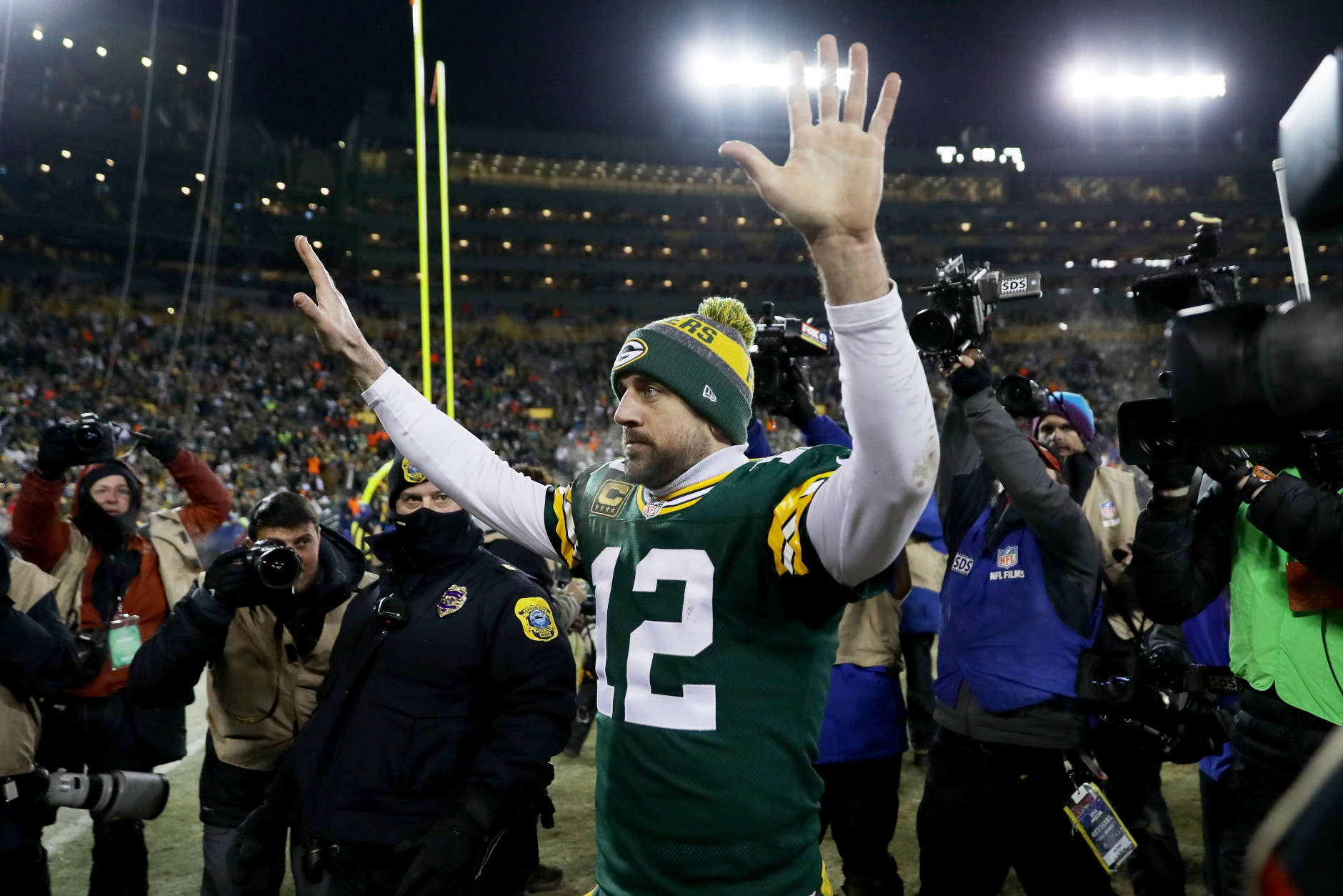 GREEN BAY, WI - JANUARY 8:  Aaron Rodgers #12 of the Green Bay Packers walks off the field after beating the New York Giants 38-13 in the NFC Wild Card game at Lambeau Field on January 8, 2017 in Green Bay, Wisconsin. (Photo by Jonathan Daniel/Getty Images)