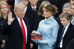 WASHINGTON, DC - JANUARY 20:  (L-R) U.S. President Donald Trump takes the oath of office as his wife Melania Trump holds the bible and his son Barron Trump looks on, on the West Front of the U.S. Capitol on January 20, 2017 in Washington, DC. In today's inauguration ceremony Donald J. Trump becomes the 45th president of the United States.  (Photo by Chip Somodevilla/Getty Images)
