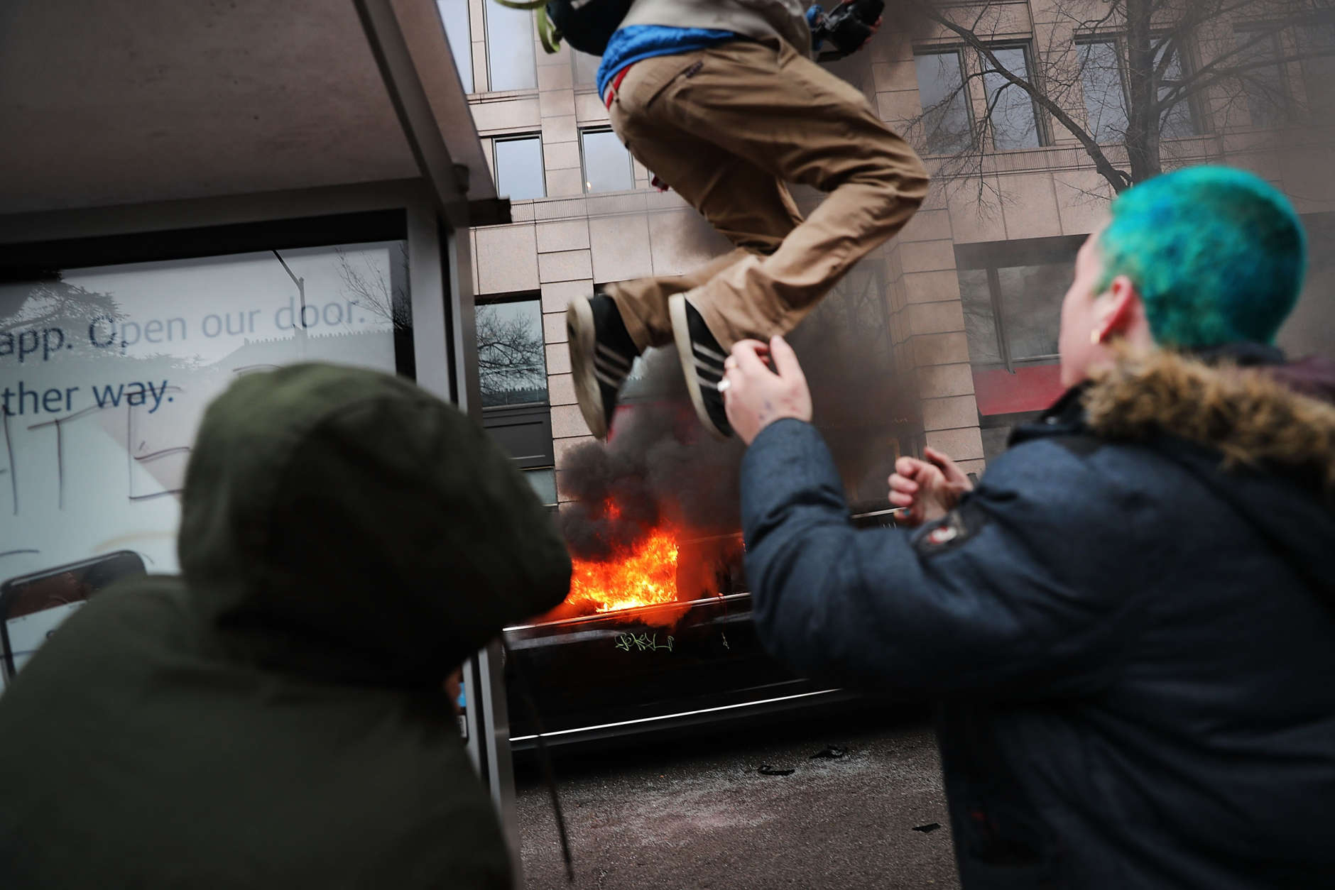 WASHINGTON, DC - JANUARY 20:  Police and demonstrators clash in downtown Washington after a limo was set on fire following the inauguration of President Donald Trump on January 20, 2017 in Washington, DC. Washington and the entire world have watched the transfer of the United States presidency from Barack Obama to Donald Trump, the 45th president.  (Photo by Spencer Platt/Getty Images)