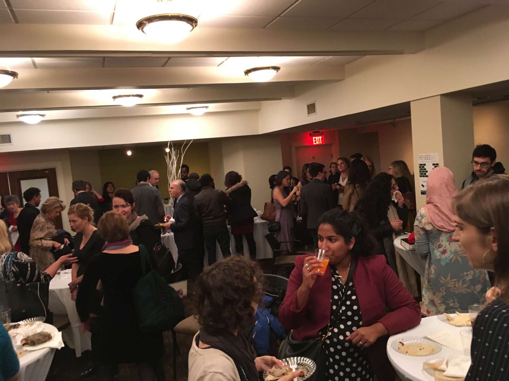 A packed downstairs social hall at Tuesday night's Refugee Ball, an event to show solidarity with members of refugee and immigrant communities and to educate the public about their contributions  to society. (WTOP/Liz Anderson)