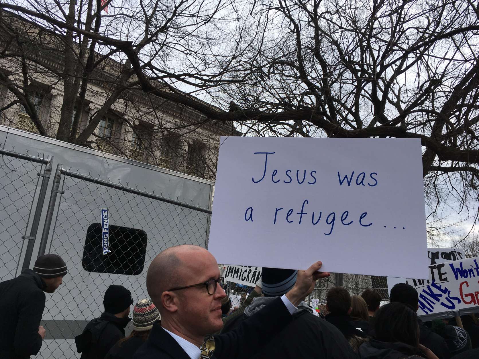Throngs of people demonstrated near the White House on Sunday, Jan. 29, 2017, in protest of President Donald Trump's ban on refugees from seven countries. (WTOP/Liz Anderson)