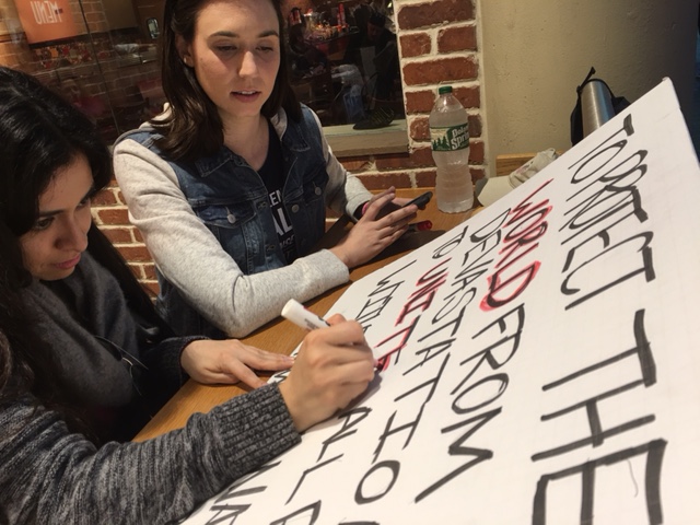 Women put the finishing touches on their signs at Union Station before heading to the Women's March on Washington on Saturday, Jan. 21, 2017. (WTOP/Jenny Glick)