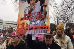 A woman carrying a sign featuring Princess Leia from "Star Wars" walks with the crowd headed toward the Women's March on Washington on Saturday, Jan. 21, 2017. (WTOP/Jenny Glick)