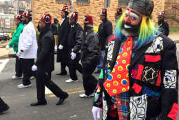 Photo of man dressed as clown marching