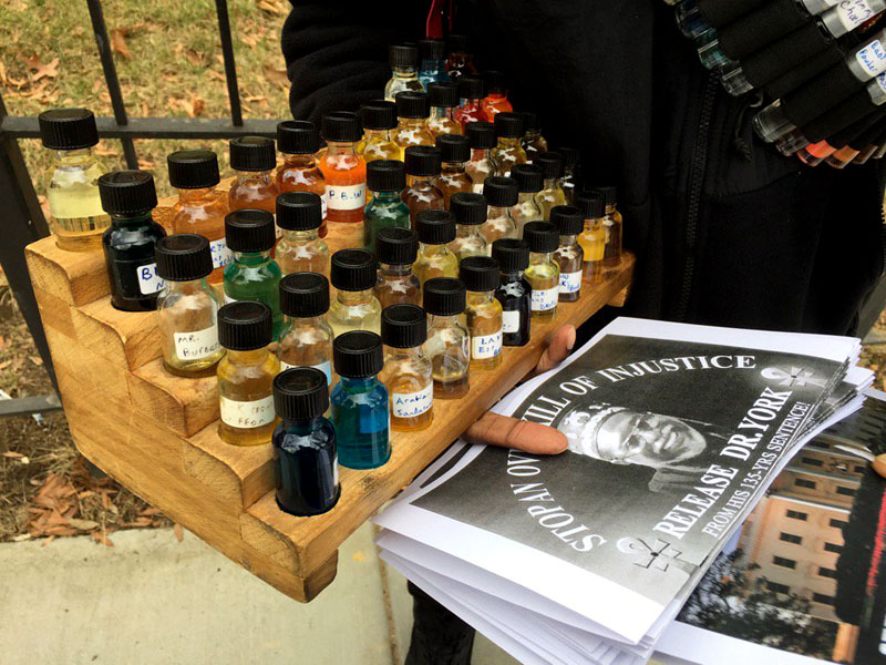 A business man sells perfumes for $5 a bottle during the 11th annual Dr. Martin Luther King, Jr. Parade in Washington, D.C. on Monday, Jan. 16, 2017. (WTOP/Kristi King)