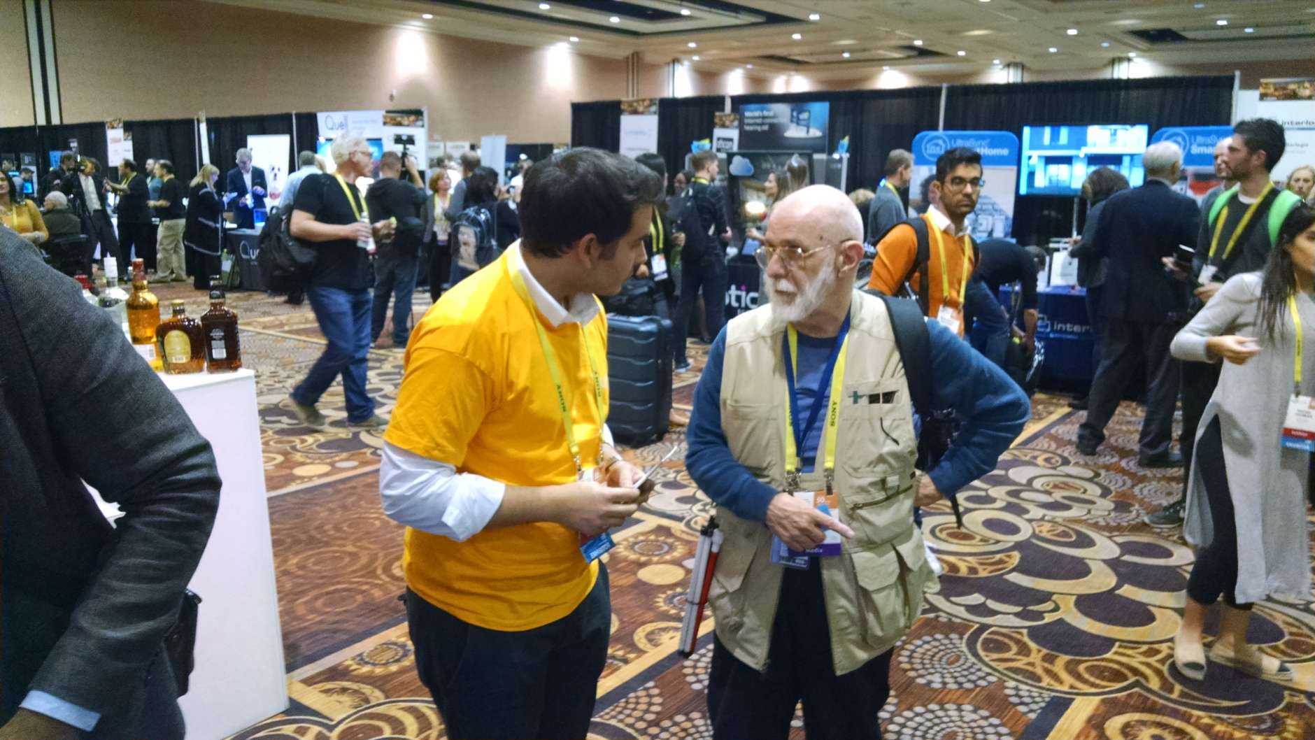 A Yummi Robotics representative visits with an attendee during "CES Unveiled." (WTOP/Steve Winter)