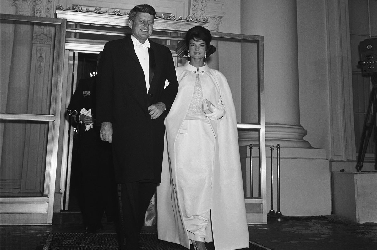 Newly-elected President and Mrs. John F. Kennedy leave the White House, in Washington, D.C., on Jan. 20, 1961, for a series of visits to inaugural balls. The first lady wore her specially-designed haute couture white silk sheath and matching coat. As the 35th President of the United States, Kennedy defeated Vice President Richard M. Nixon in one of the closest presidential elections of the 20th century by a plurality of just 114,000 votes. The Kennedys brought a cultured and glamorous era known as "Camelot" to American politics. (AP Photo/Henry Burroughs)