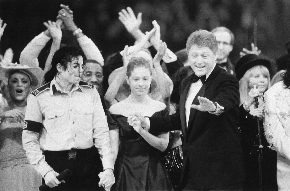 President-elect Bill Clinton and his daughter Chelsea are surrounded by stars during the finale of the Presidential Gala at the Capital Centre in Landover, Md., Jan. 20, 1993. At left is Michael Jackson and at right is Stevie Nicks of Fleetwood Mac. Comic actor Chevy Chase can be seen behind the president's head. (AP Photo/Amy Sancetta)