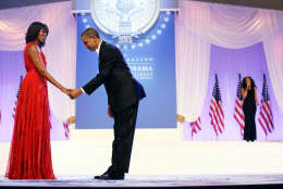 President Barack Obama bows as he and first lady Michelle Obama, wearing a ruby colored chiffon and velvet Jason Wu gown, gets ready to dance as singer Jennifer Hudson, right, sings Al Green's "Let's Stay Together" at the Inaugural Ball at the Washington Convention Center during the 57th Presidential Inauguration in Washington, Monday, Jan. 21, 2013. (AP Photo/Charles Dharapak)