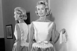 FILE - In this April 6, 1962 file photo, socialite-actress Dina Merrill models the gown she will wear at the Academy Awards presentation in Los Angeles. Merrill, the rebellious heiress who defied her super-rich parents to become an actress, died Monday, May 22, 2017, at age 93.  (AP Photo/Harold P. Matosian, File)