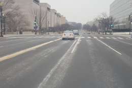 Downtown D.C. saw a light dusting by 9:30 a.m Saturday, with flurries not yet sticking to the windshield. (WTOP/Ralph Fox)
