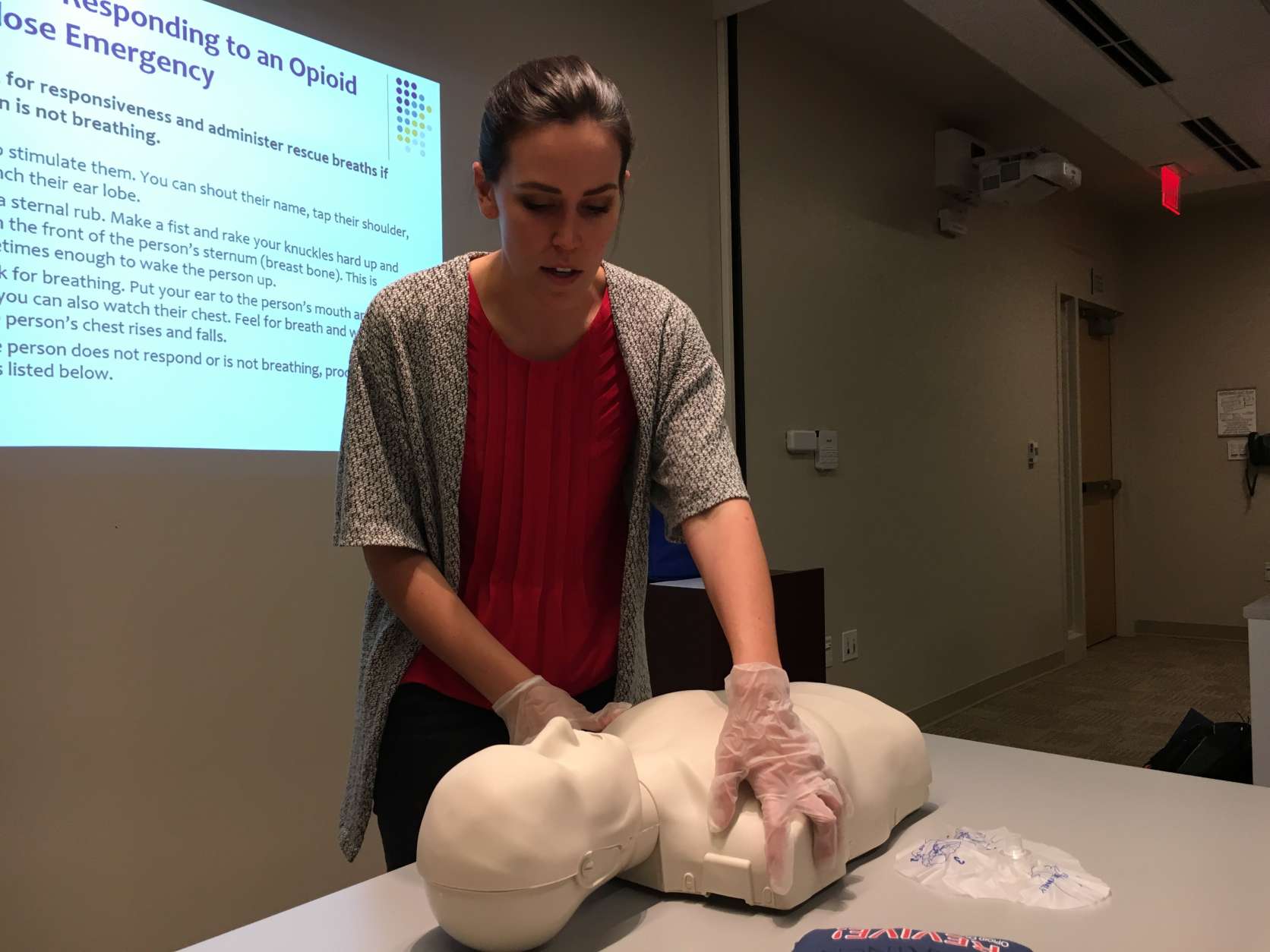 Lovitt shows class participants what to do if a loved one is overdosing. First, check for a response. Give them a light shake or call their name to see if the person is unconscious. (WTOP/Jamie Forzato)