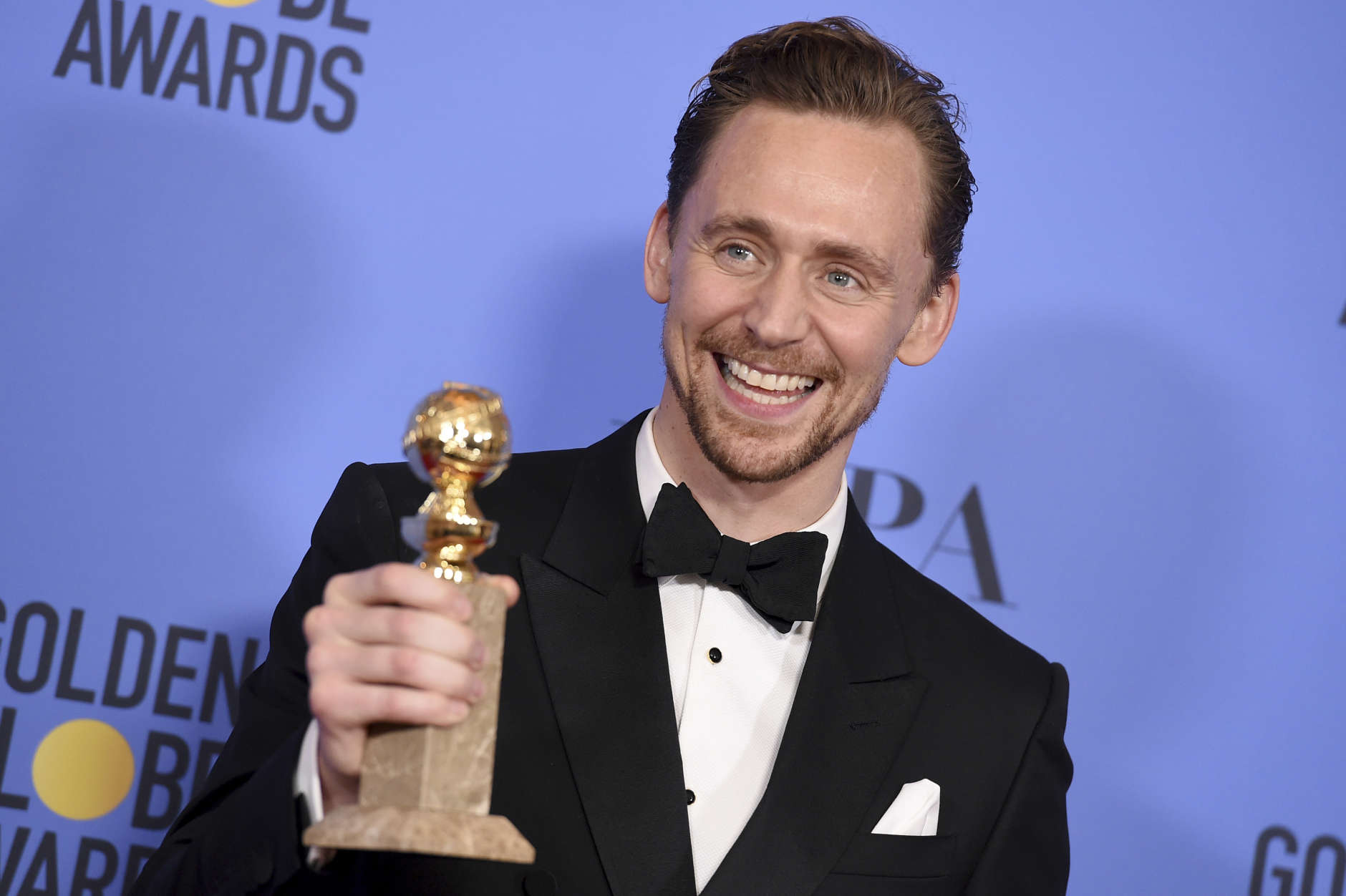 Tom Hiddleston poses in the press room with the award for best performance by an actor in a limited series or a motion picture made for television for "The Night Manager" at the 74th annual Golden Globe Awards at the Beverly Hilton Hotel on Sunday, Jan. 8, 2017, in Beverly Hills, Calif. (Photo by Jordan Strauss/Invision/AP)