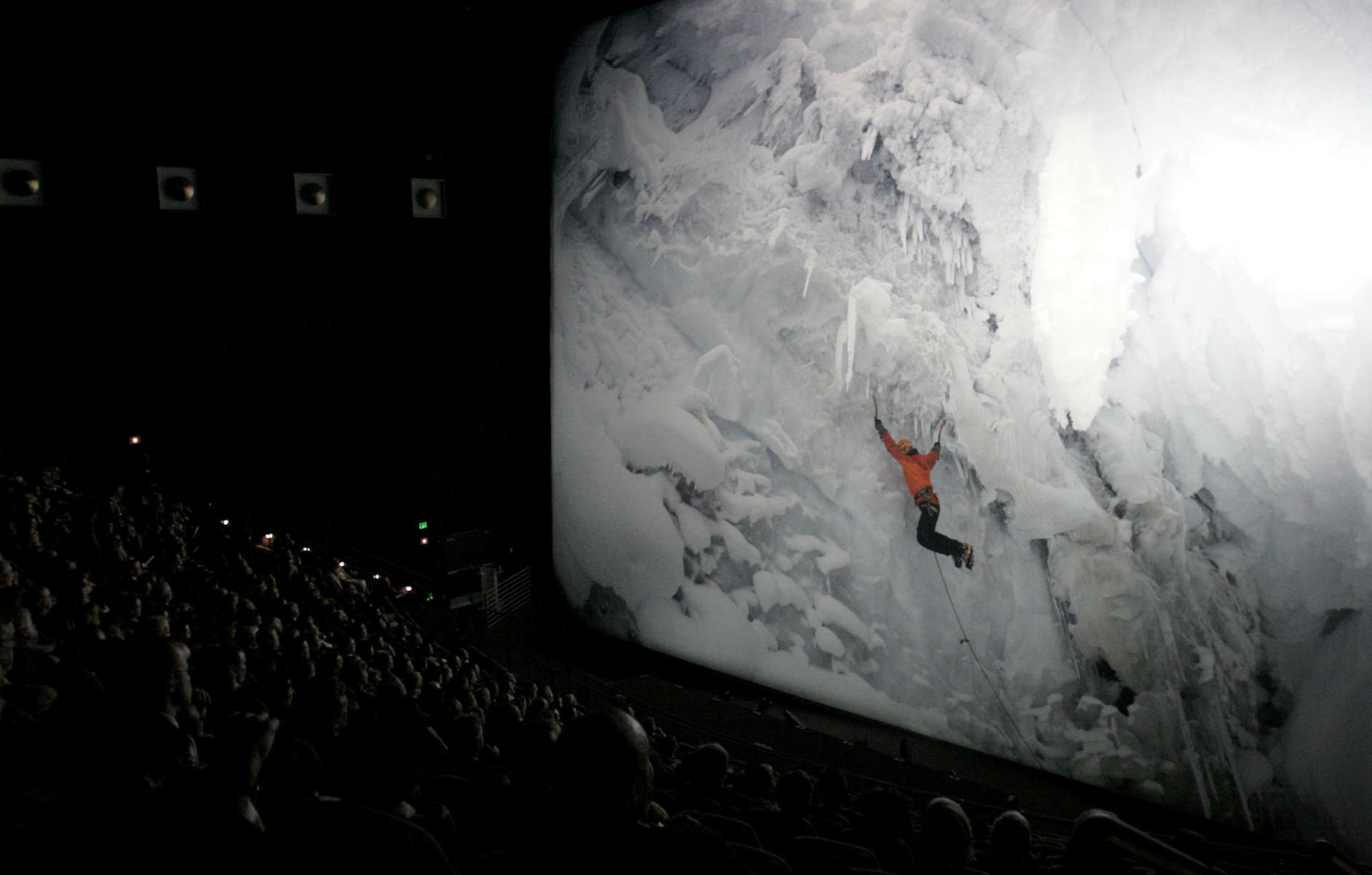 The audience watches the world premier of the Imax film "The Alps" at the Smithsonian's National Museum of Natural History in Washington, Wednesday, March 7, 2007. The film documents John Harlin III's ascent of the Eiger in the Swiss Alps 40 years after his father died on the same mountain. (AP Photo/Caleb Jones)