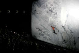 The audience watches the world premier of the Imax film "The Alps" at the Smithsonian's National Museum of Natural History in Washington, Wednesday, March 7, 2007. The film documents John Harlin III's ascent of the Eiger in the Swiss Alps 40 years after his father died on the same mountain. (AP Photo/Caleb Jones)