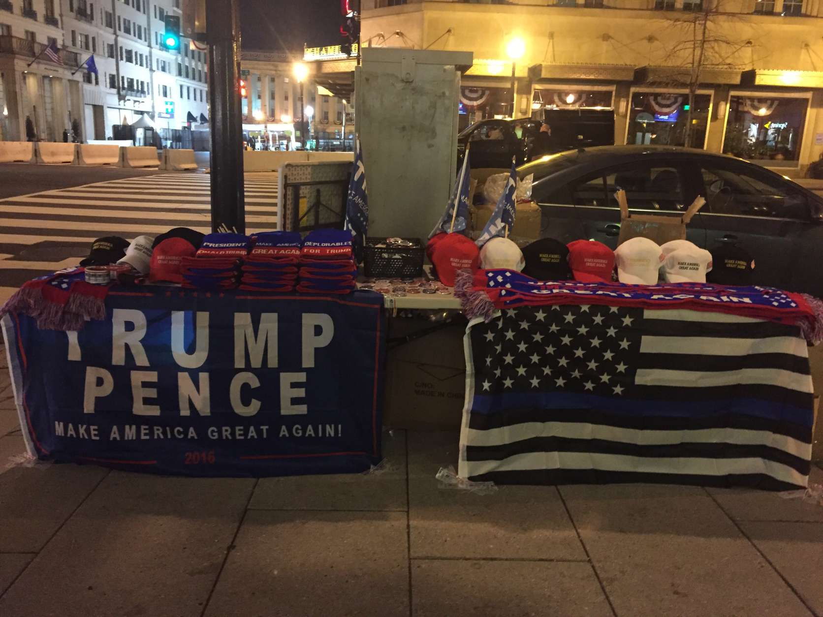 A New Yorker headed to New York University sells Trump merchandise near the White House early Friday morning. (WTOP/Dennis Foley)