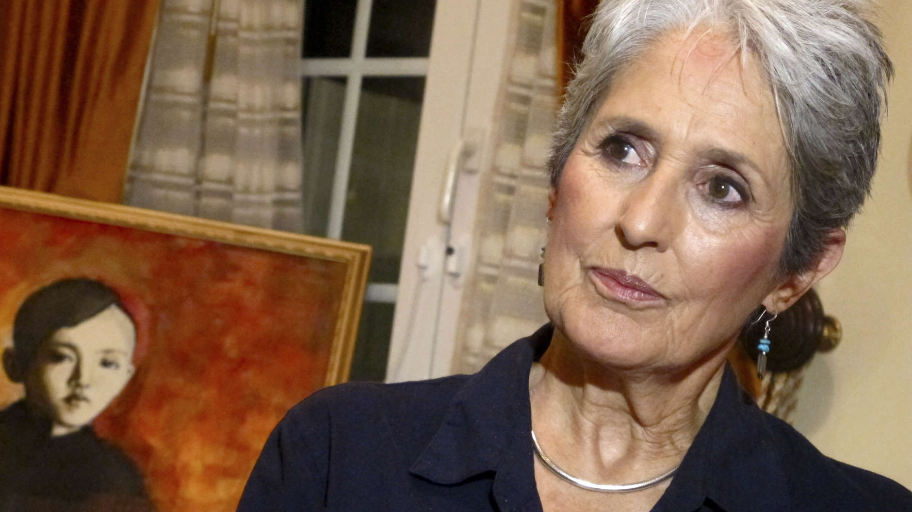 In this April 5, 2013 photo, Joan Baez speaks to a reporter in her hotel room in Hanoi, Vietnam. The folk singer and social activist visited Vietnam recently for the first time since she came to the country in December 1972 as part of an American peace delegation. Baez painted the picture of the young boy during her recent stay in Hanoi.  (AP Photo/Dinh Hau)