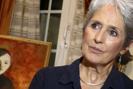 In this April 5, 2013 photo, Joan Baez speaks to a reporter in her hotel room in Hanoi, Vietnam. The folk singer and social activist visited Vietnam recently for the first time since she came to the country in December 1972 as part of an American peace delegation. Baez painted the picture of the young boy during her recent stay in Hanoi.  (AP Photo/Dinh Hau)