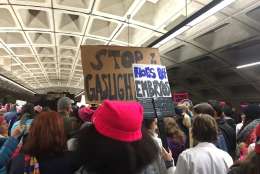 Chants of "Fired up, ready to go" were heard at L'Enfant station, sparking cheers among people headed toward the Women's March on Washington Saturday morning, Jan. 21, 2017. (WTOP/Max Smith)