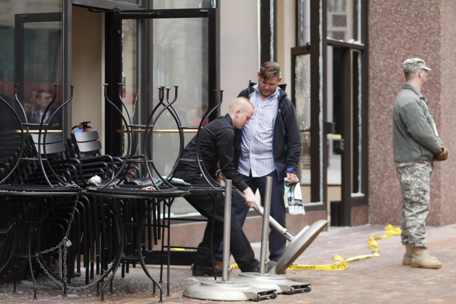 Workers clean up broken glass at a Starbucks at 12th and I streets NW. Protesters vandalized several businesses near Franklin Square just before Donald Trump's inauguration ceremony was about to begin. Police said they arrested numerous protesters who are charged with rioting. (WTOP/Kate Ryan)