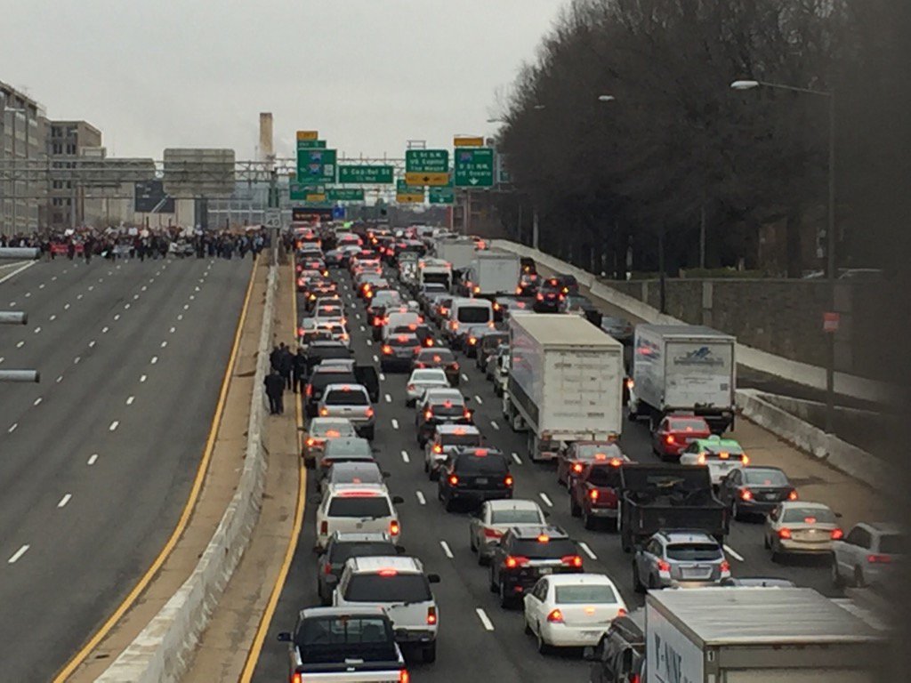 Protesters stop traffic as they march across the freeway. (WTOP/Rob Woodfork)