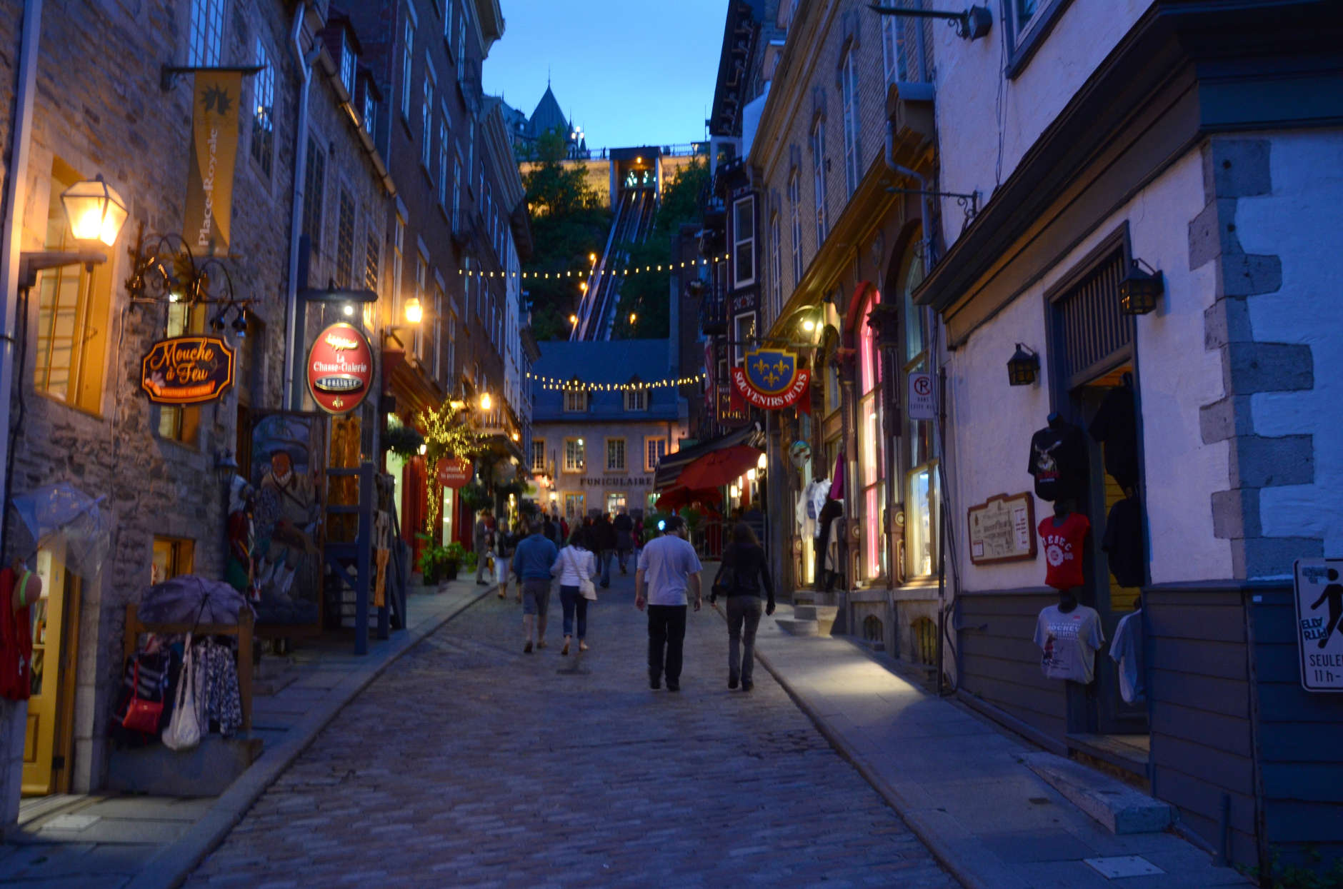 People stroll the cobblestoned streets of Old Quebec in this Aug. 5, 2015, photo. Streets of the walled city will come alive July 18-23 when more than 40 tall ships in an international fleet are anchored in the port. A parade of more than 3,000 sailors, waterfront performances and fireworks are on tap for the event. (AP Photo/Cal Woodward)