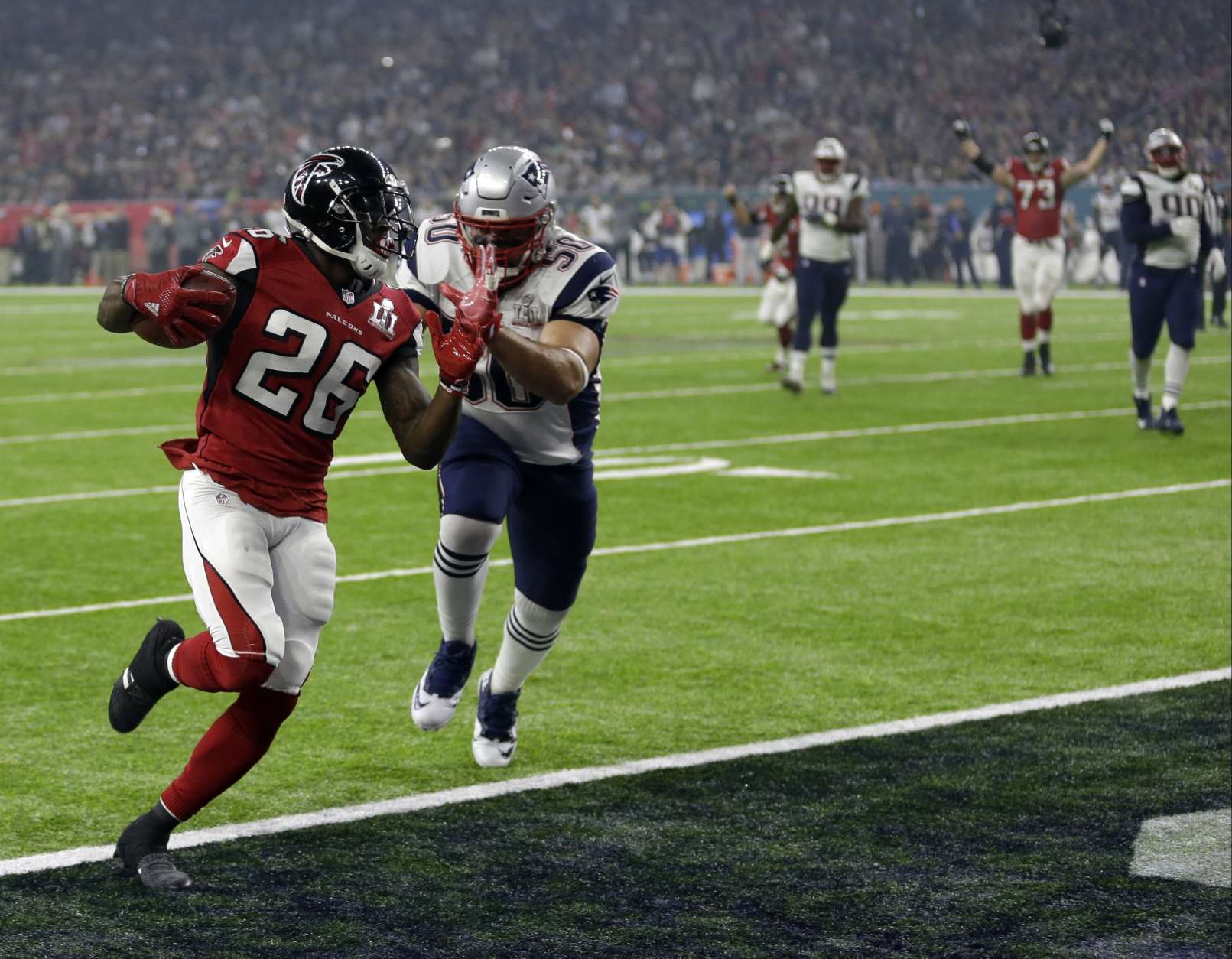 Atlanta Falcons' Tevin Coleman (26) runs to the end zone for a touchdown against New England Patriots' Rob Ninkovich (50) during the second half of the NFL Super Bowl 51 football game Sunday, Feb. 5, 2017, in Houston. (AP Photo/David J. Phillip)