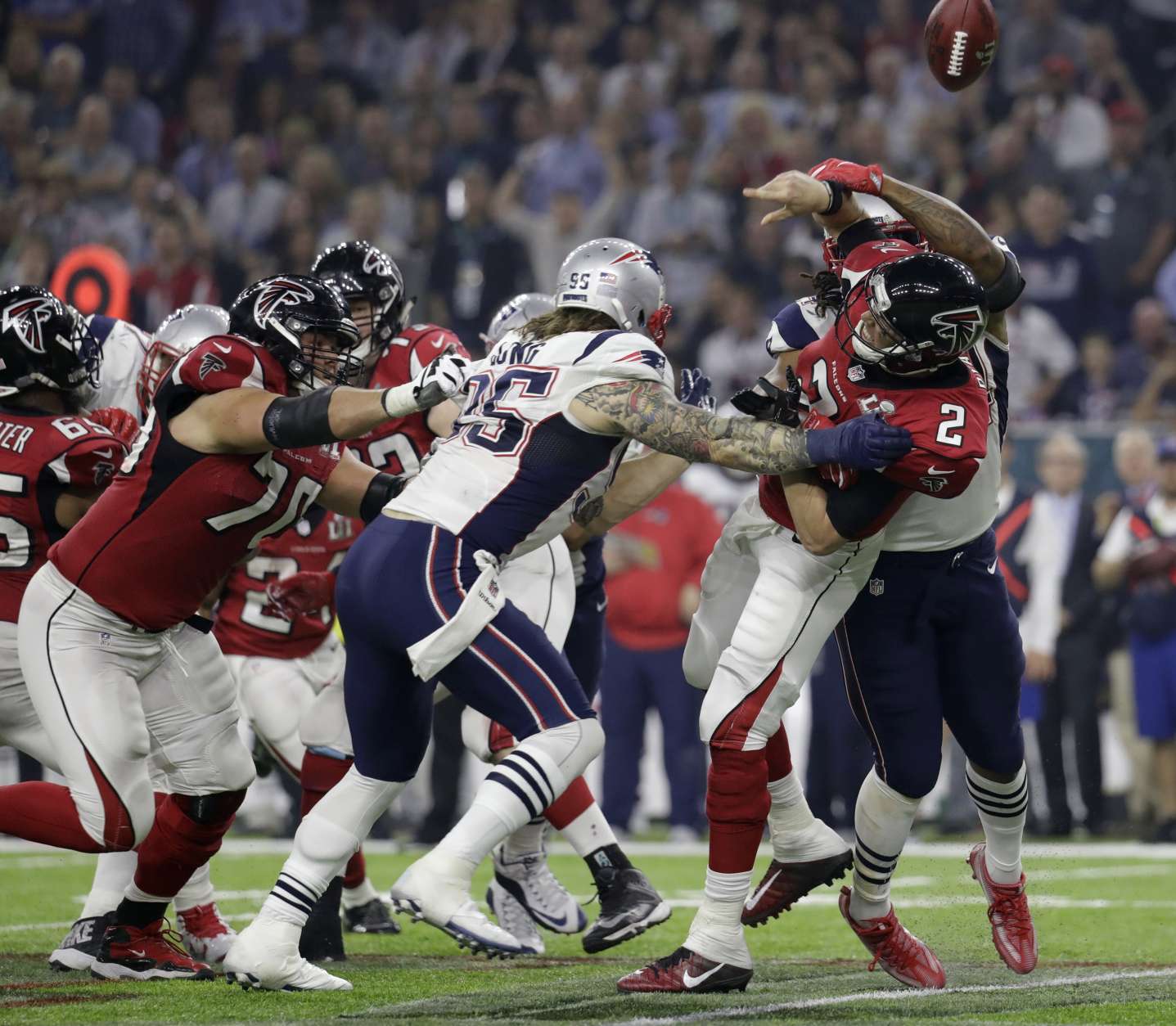 Atlanta Falcons' Matt Ryan (2) fumbles as he is hit by New England Patriots' Dont'a Hightower, obscured at rear, during the second half of the NFL Super Bowl 51 football game Sunday, Feb. 5, 2017, in Houston. (AP Photo/Eric Gay)