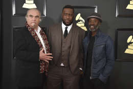 Steve Berkowitz, from left, Robert Glasper, and Don Cheadle arrive at the 59th annual Grammy Awards at the Staples Center on Sunday, Feb. 12, 2017, in Los Angeles. (Photo by Jordan Strauss/Invision/AP)
