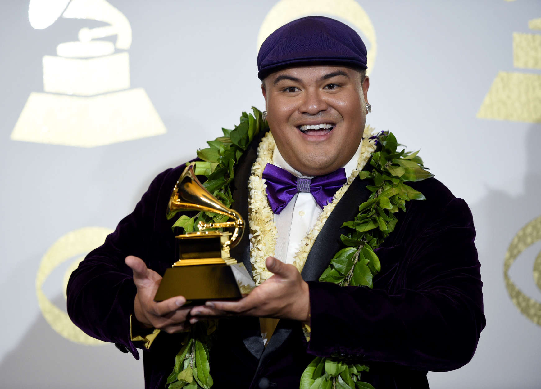 Kalani Pe'a poses in the press room with the award for best regional roots music album for "E Walea" at the 59th annual Grammy Awards at the Staples Center on Sunday, Feb. 12, 2017, in Los Angeles. (Photo by Chris Pizzello/Invision/AP)