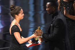 Alicia Vikander, left, presents Mahershala Ali with the award for best actor in a supporting role for "Moonlight" at the Oscars on Sunday, Feb. 26, 2017, at the Dolby Theatre in Los Angeles. (Photo by Chris Pizzello/Invision/AP)