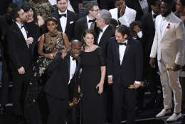 Barry Jenkins, foreground left, and the cast accept the award for best picture for "Moonlight" at the Oscars on Sunday, Feb. 26, 2017, at the Dolby Theatre in Los Angeles. (Photo by Chris Pizzello/Invision/AP)