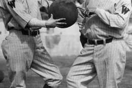 Al Schact, left, and Nick Altrock of the Washington Senators strike a familiar pose at spring training camp in Tampa, Florida, Feb. 27, 1929. (AP Photo)