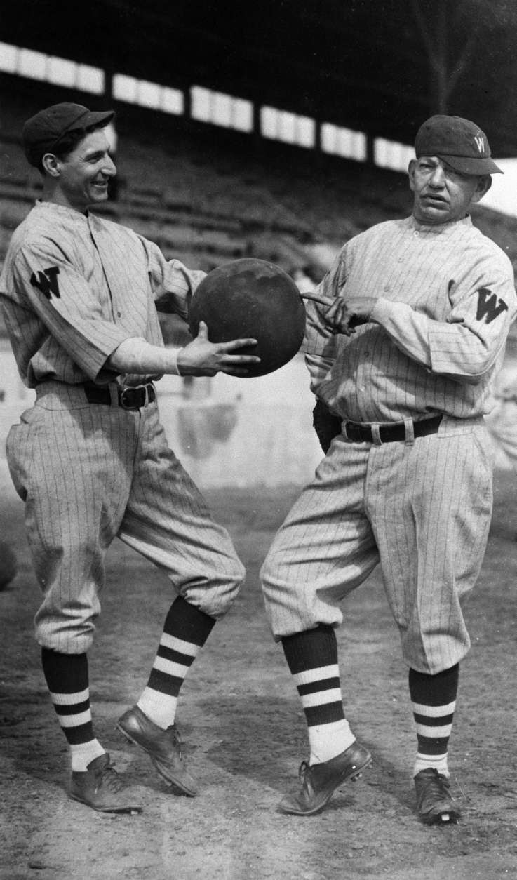 Al Schact, left, and Nick Altrock of the Washington Senators strike a familiar pose at spring training camp in Tampa, Florida, Feb. 27, 1929. (AP Photo)