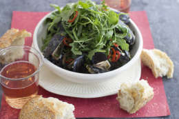 This Jan. 5, 2015 photo shows mussels in Dijon orange sauce with arugula in Concord, N.H. (AP Photo/Matthew Mead)