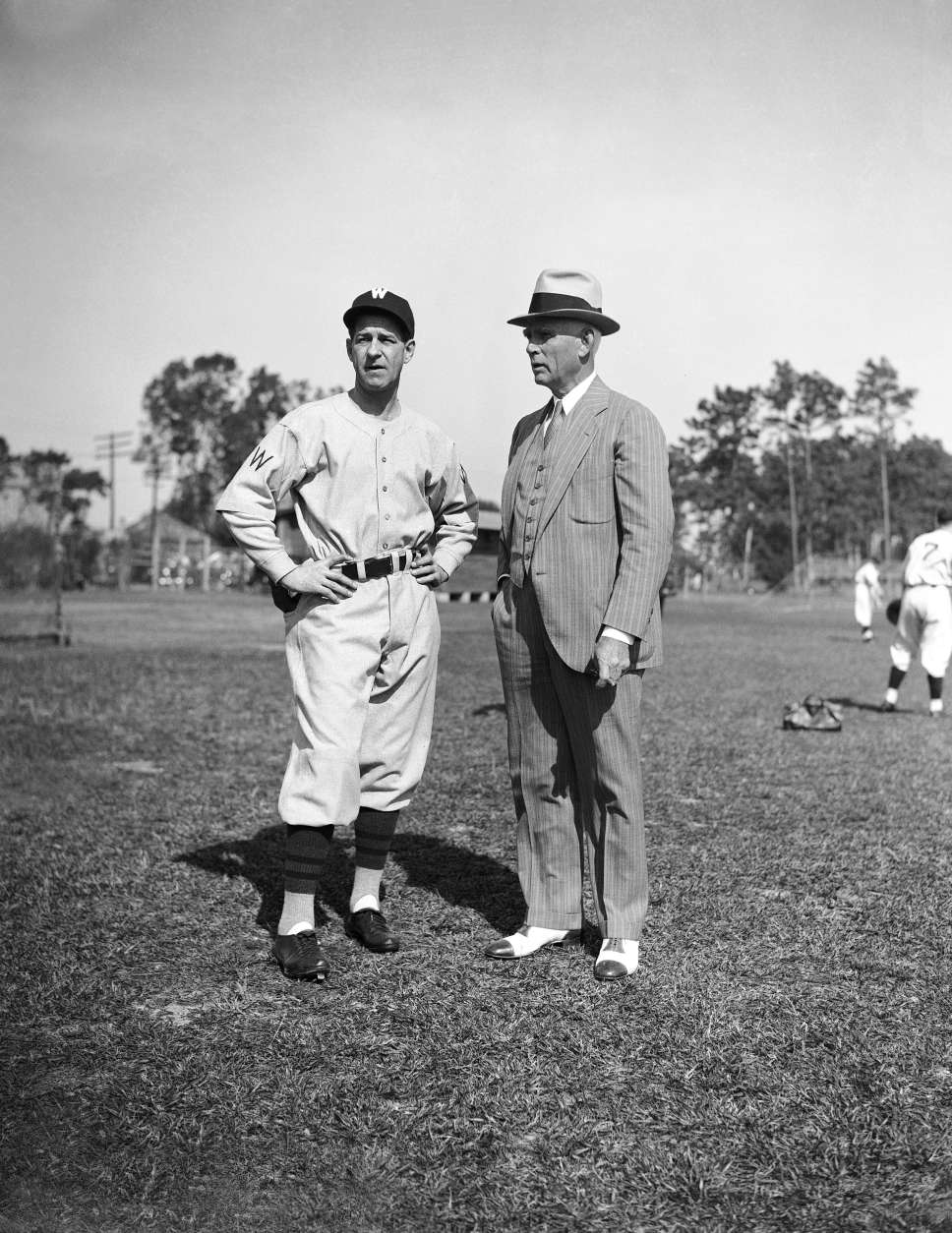 Back in his old post as manager of the Washington Senators, Stanley (Bucky) Harris, left, compares notes with owner Clark Griffith as the team starts spring training in Orlando, Florida, Feb. 26, 1936. (AP Photo)