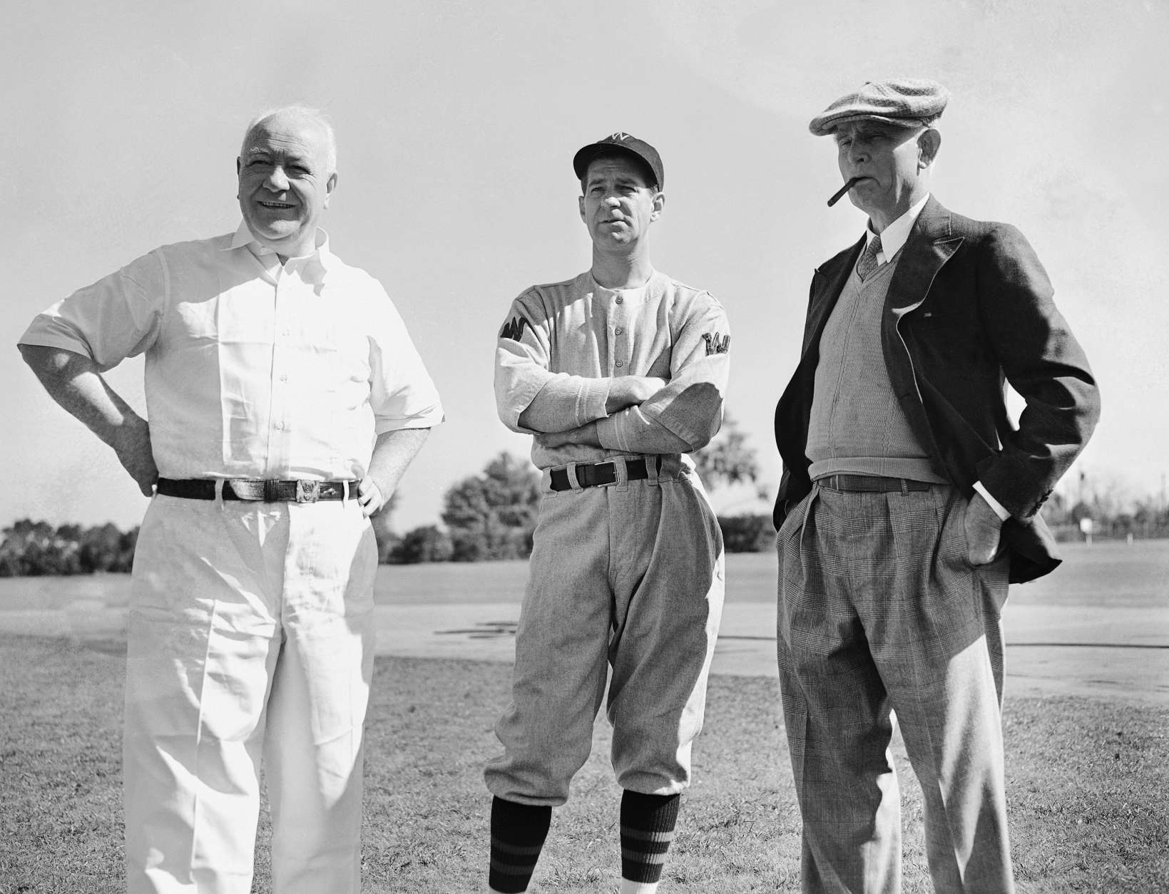 The three leaders of the Washington Senators, left to right: Mike Martin, trainer, coach Bucky Harris, and owner Clark Griffith, looked the boys over with critical eyes, as spring training got underway at Orlando, Florida, Feb. 28, 1938. (AP Photo)